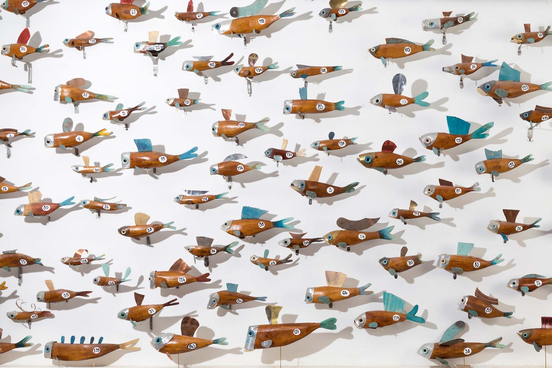 Stefano Prina Wall of Fishes Installation of 170 wooden fish italiano plurale